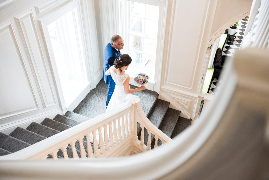 Surrey Wedding venues, father and daughter alk down the grand staircase 