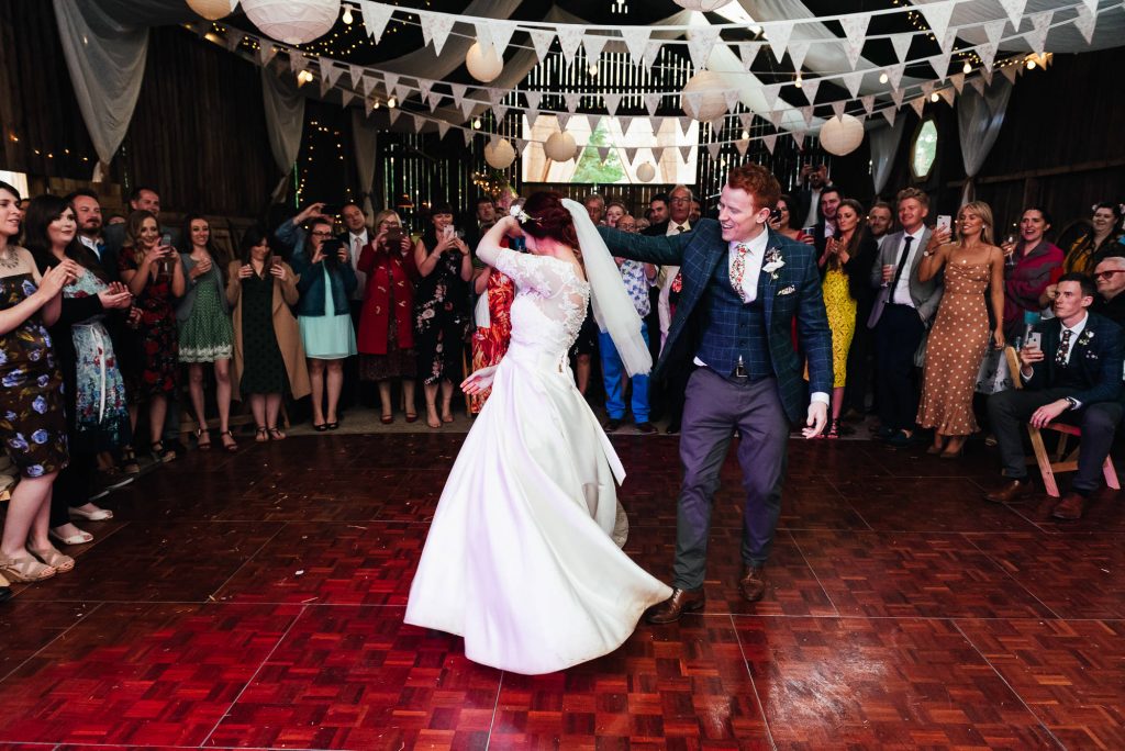 Couple dance to Everywhere by Fleetwood Mac in a rustic barn wedding in Yorkshire