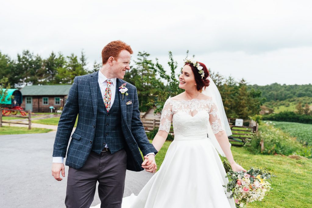 Natural wedding portrait as couple walks together at Deepdale Farm
