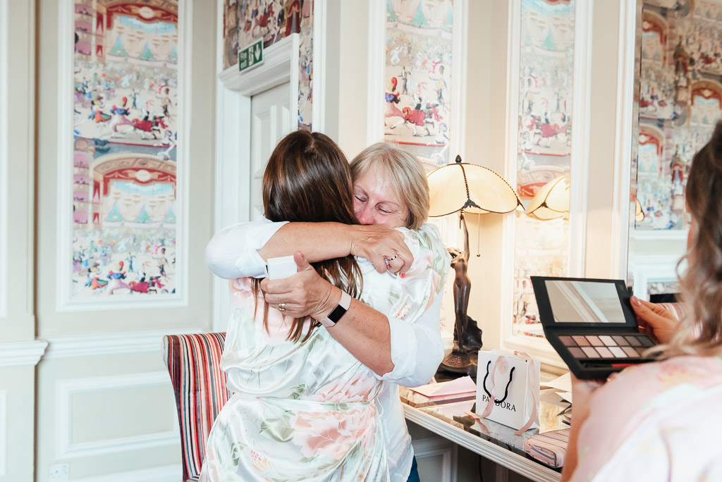Mother and daughter embrace emotionally, Surrey wedding photography