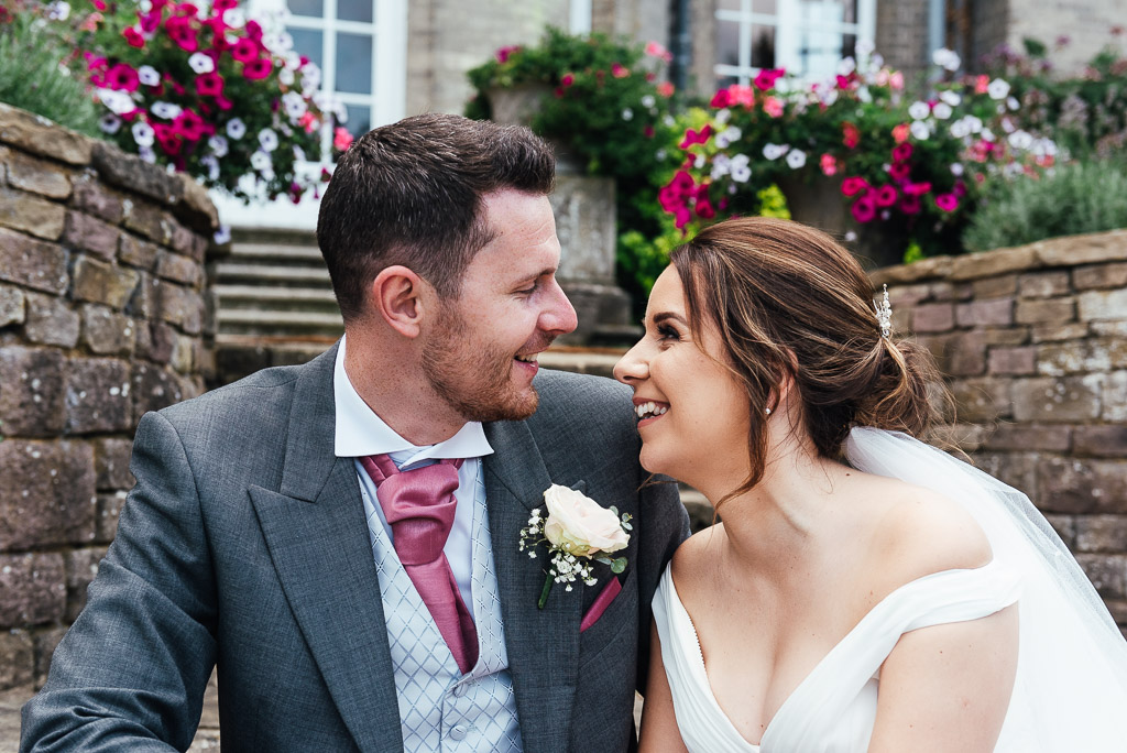 Couple lovingly look into each others eyes for a natural wedding portrait