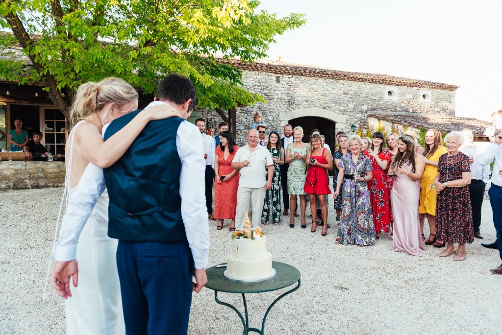 Guests watch as the couple cut the wedding cake 