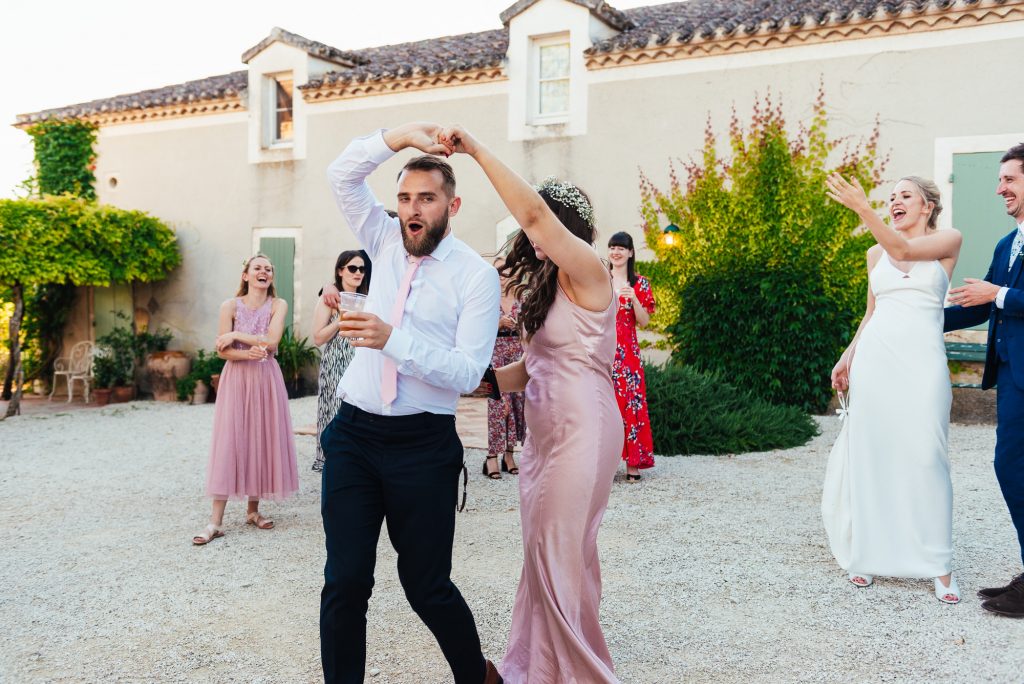 Guests join in for first dance in French courtyard wedding