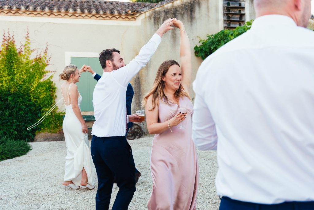 Guests join in for first dance in French courtyard wedding