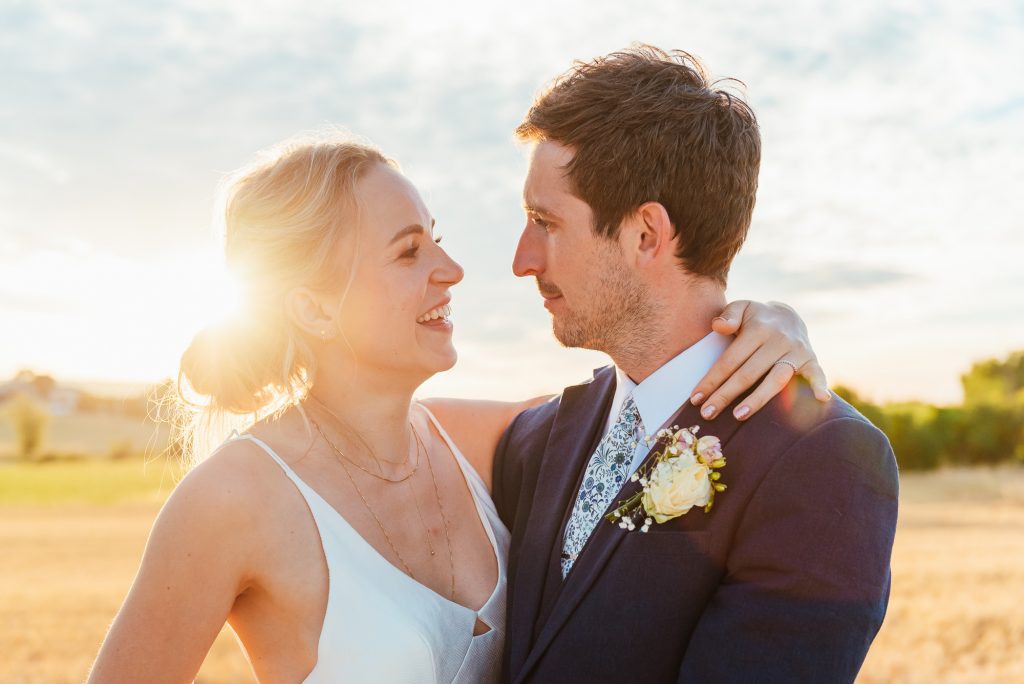 Outdoor wedding photography portrait at a romantic sunset with soft warm romantic light