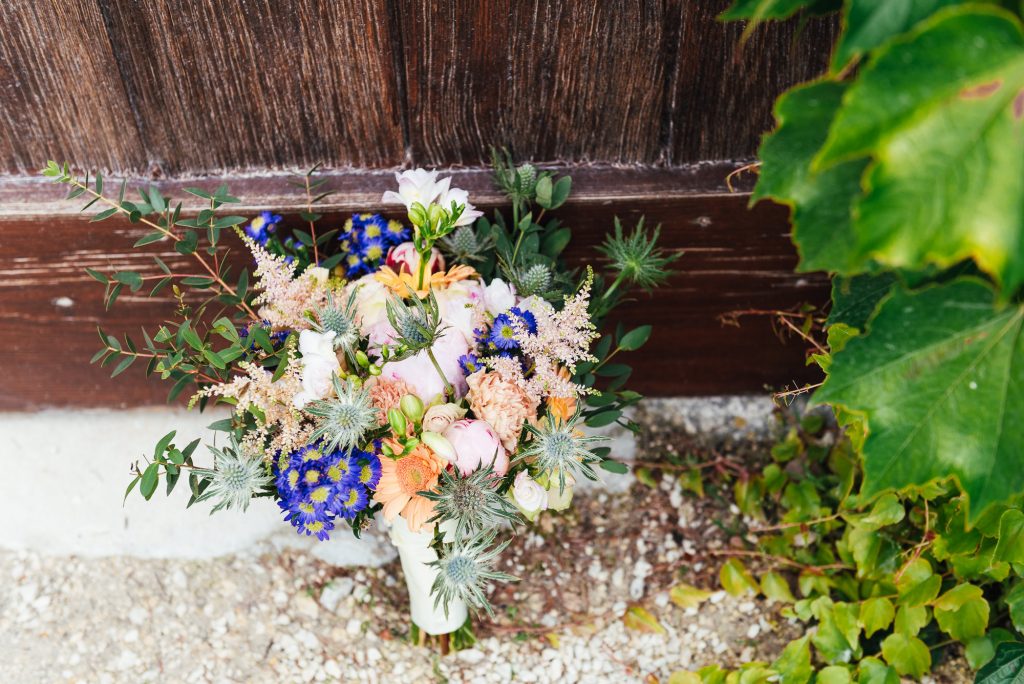 home made bouquet of flowers with wild blooms and green foliage