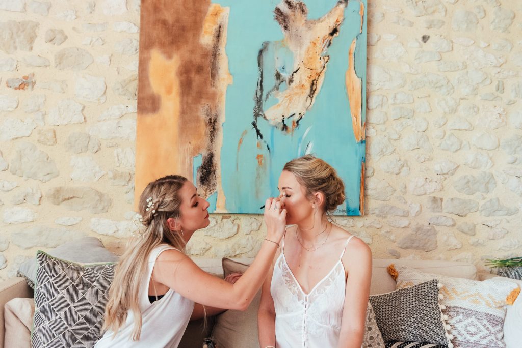 Sisters help each other get ready for bridal preparation 
