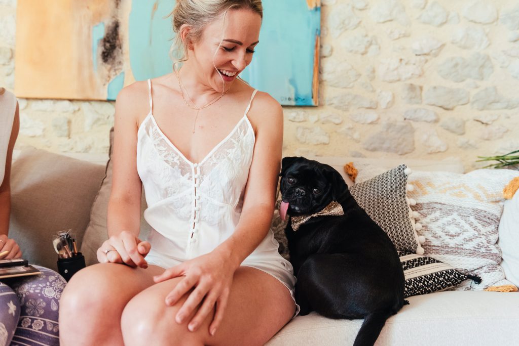 Bride getting ready with her pug dog
