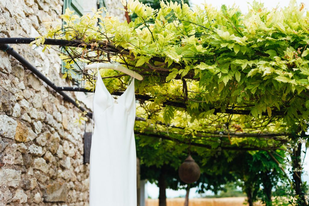 Topshop wedding dress hanging amongst vineyards, destination wedding photography