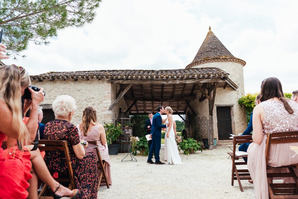 First kiss during romantic outdoor wedding ceremony France