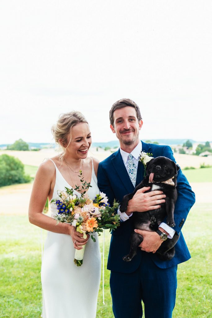 Gorgeous married couple with Pug dog, destination wedding photography