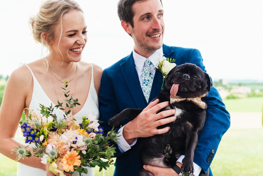 Gorgeous married couple with Pug dog 