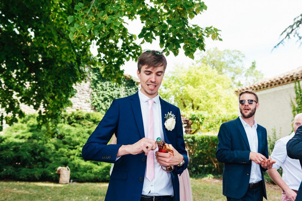 Bridesmaid opens Champagne at wedding