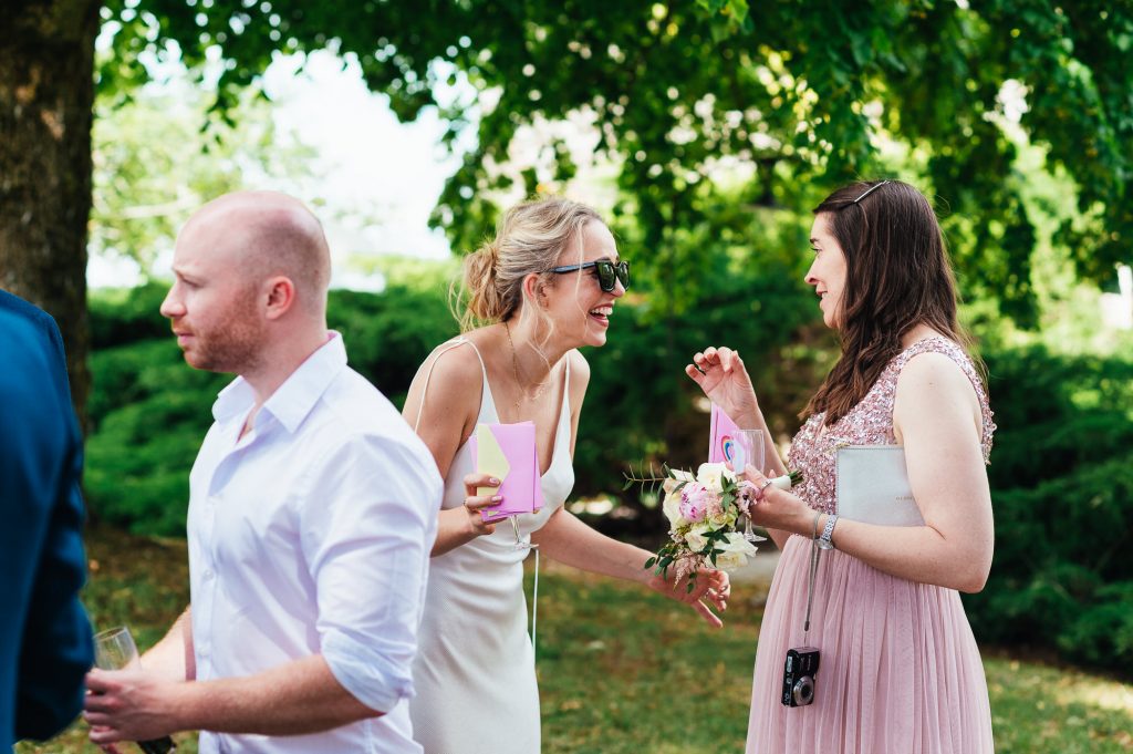 Cheerful bride laughs and chats with guests