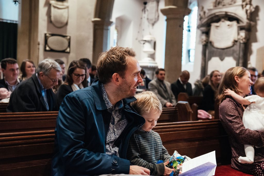Family and friends gather in church for baby christening 