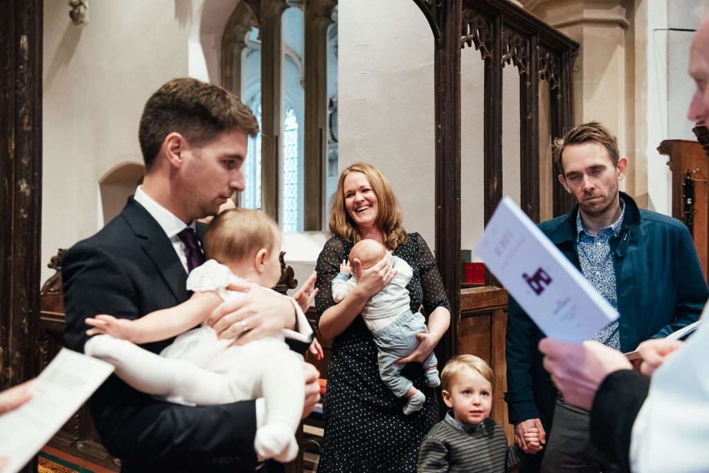 Godparents gather with parents for christening ceremony