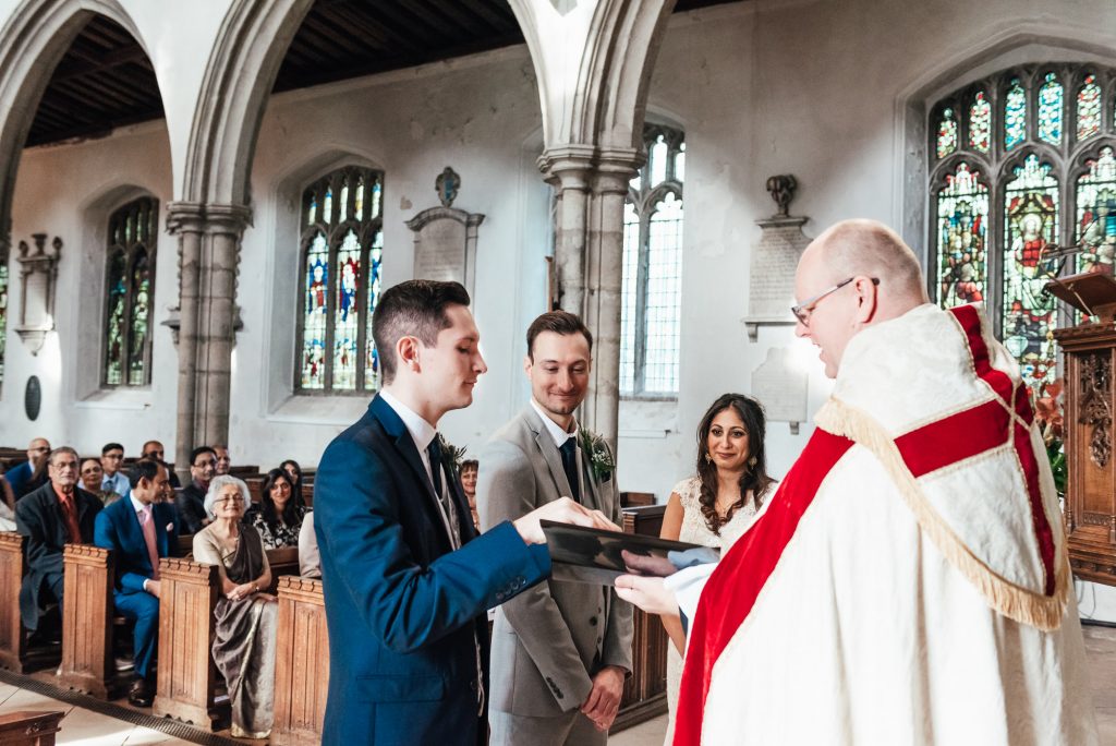 Best man brings the wedding rings to the vicar