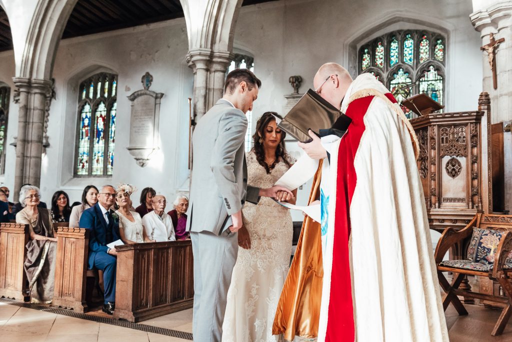 Vicar offers a blessing to the newly married couple