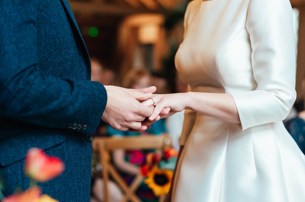 Ring exchange moment at Cain Manor wedding ceremony 