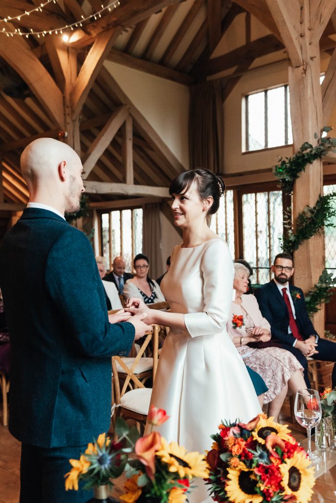 Ring exchange moment at Cain Manor wedding ceremony 