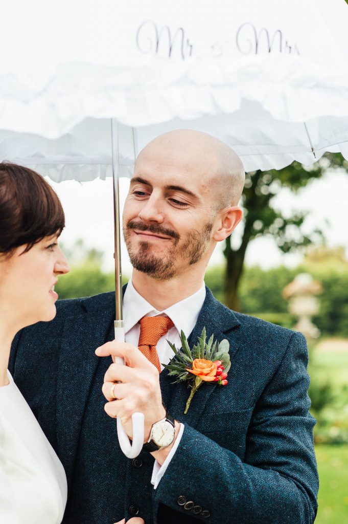 Handsome groom smiles at his bride, Cain Manor wedding photography