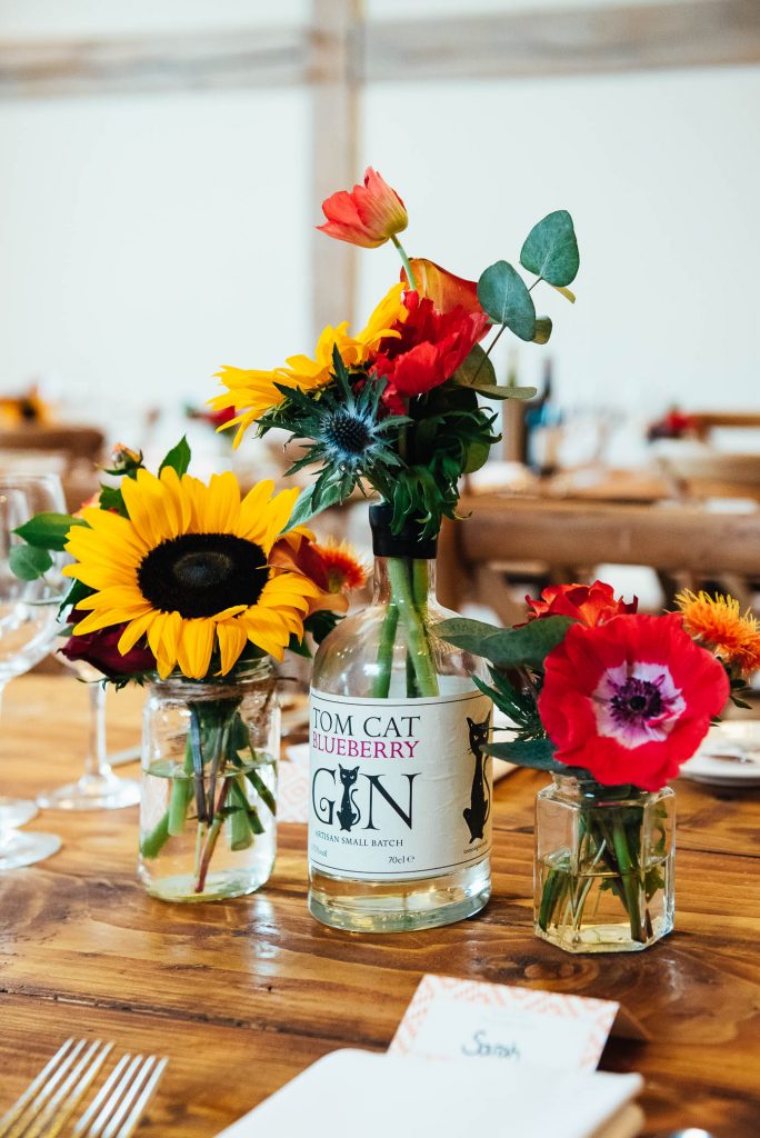 Bespoke wedding floral arrangement in classic gin bottle vase