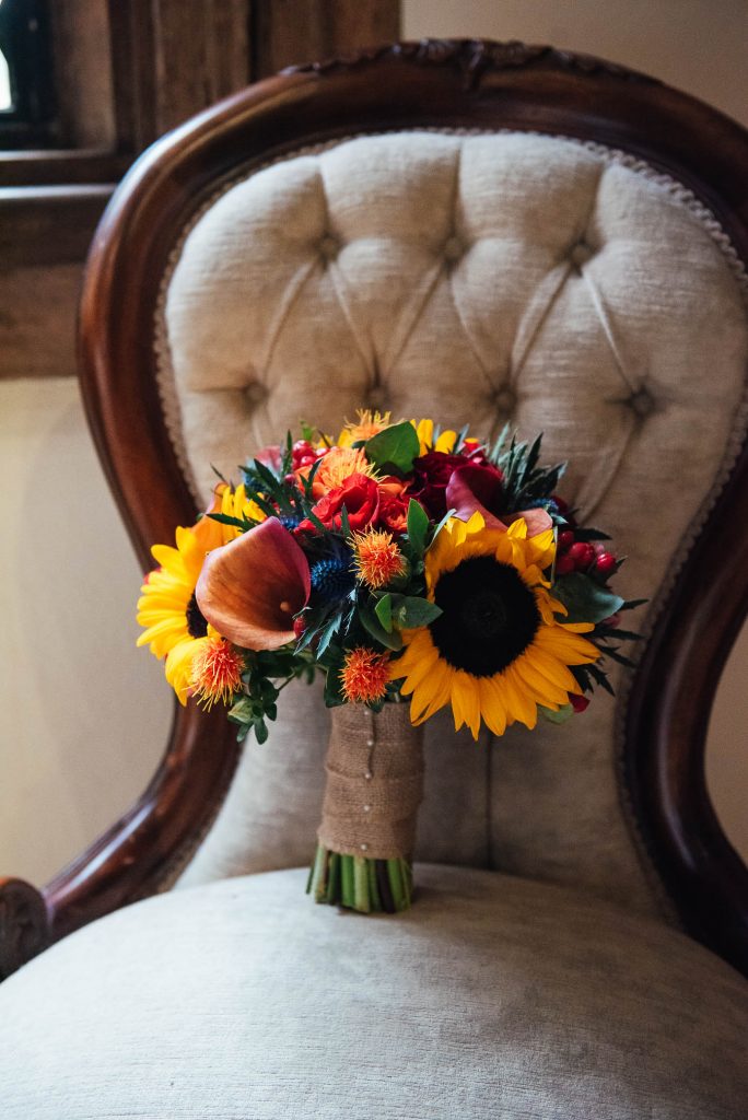 Autumnal Wedding bouquet filled with sunflowers, lilies and sea holly