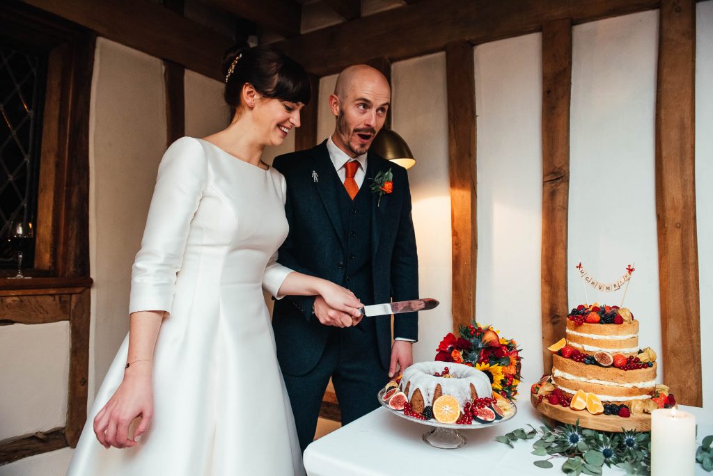 Bride and groom cut their wedding cake together