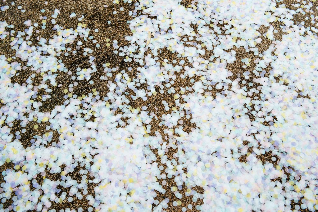 Confetti on the ground after couple walk down the aisle