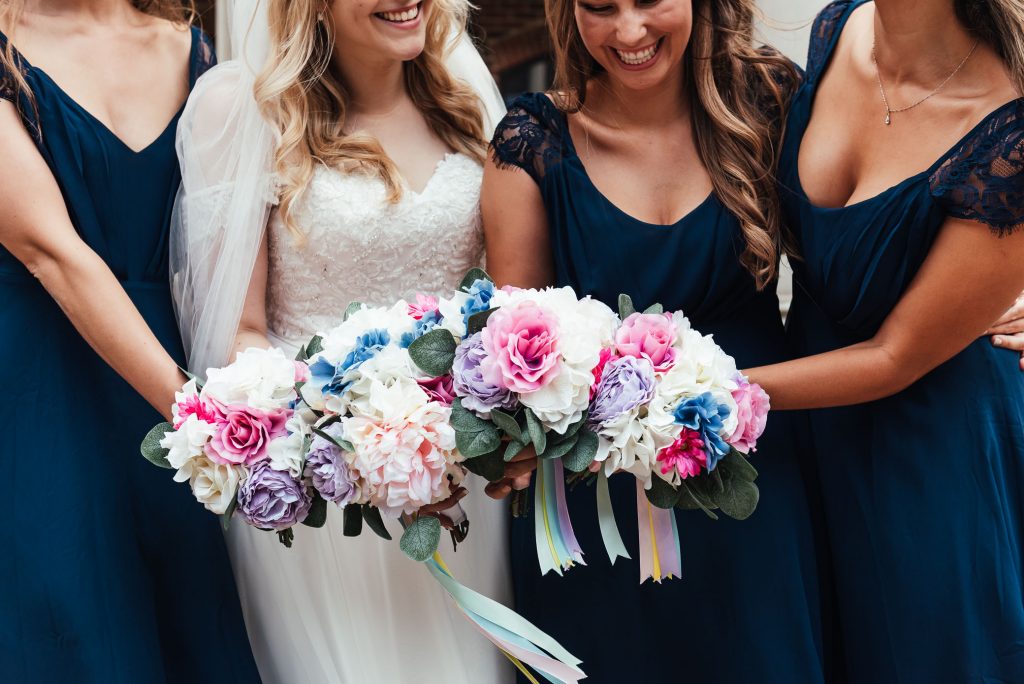 Fun group photography with bridesmaids and flowers