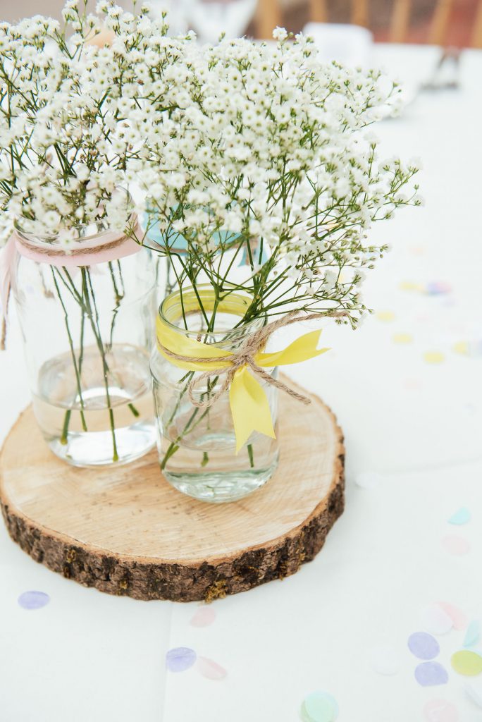 Rustic wooden table setting with soft white flower floral decoration