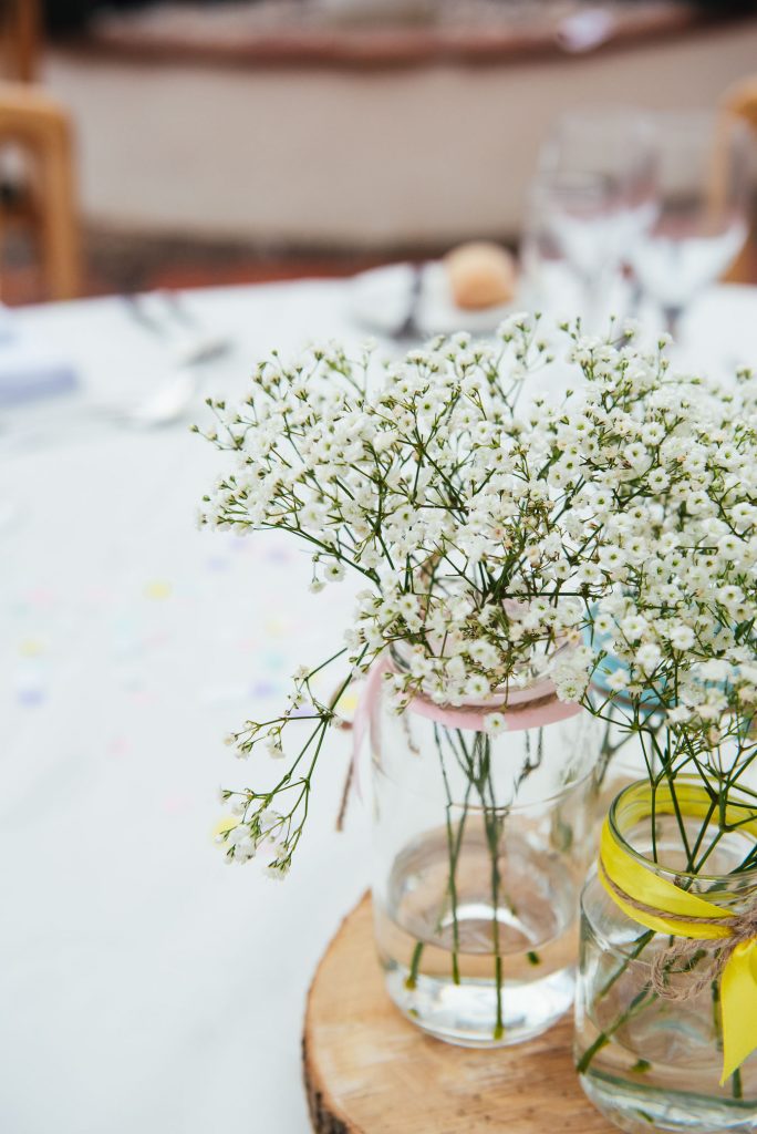 Rustic wooden table setting with soft white flower floral decoration