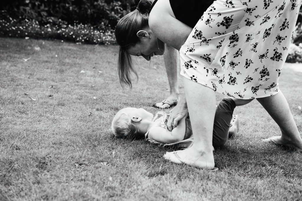Black and white image of mother and daughter playing