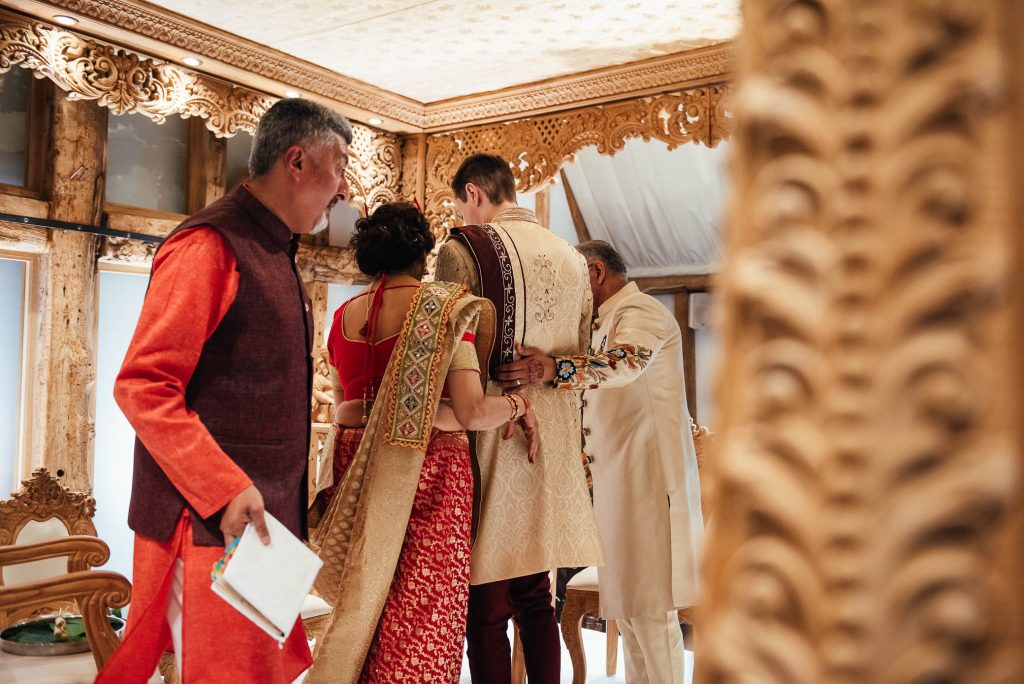 Parents greet the groom in Hindu wedding ceremony
