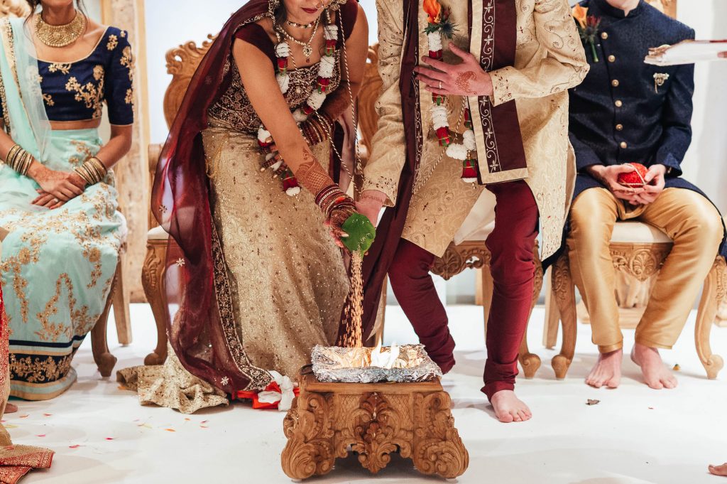 Bride and groom perform sacrificial fire ritual, Hindu South Farm wedding