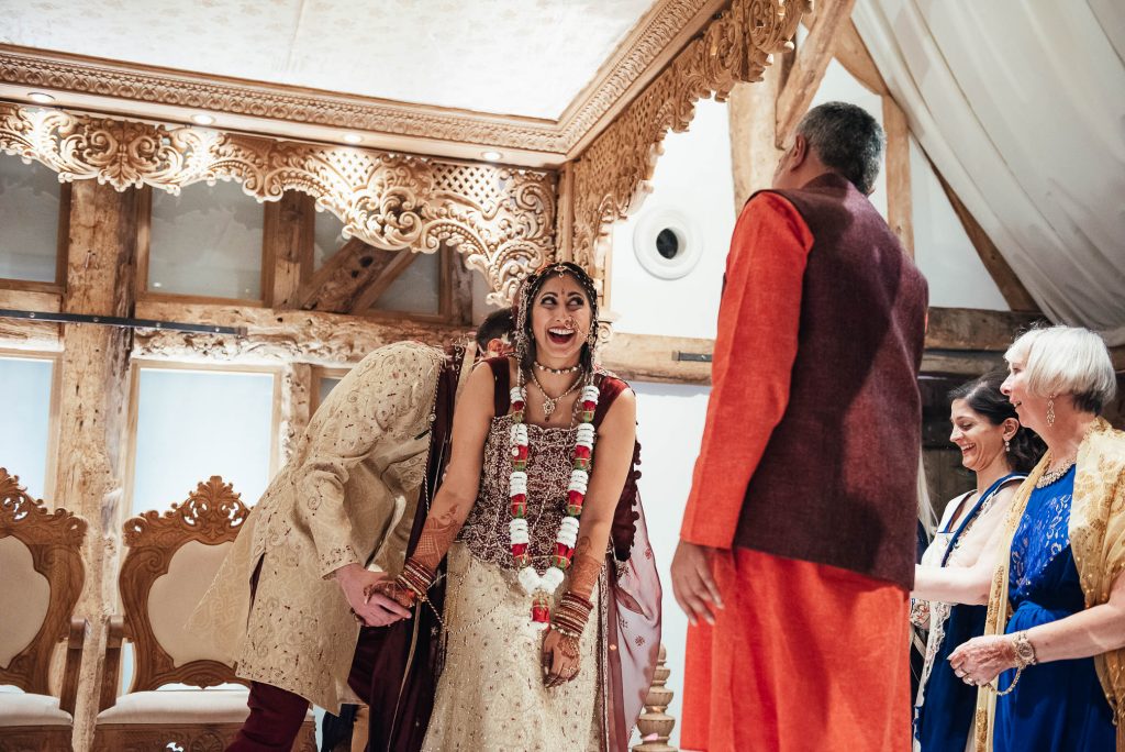 Family members throw flower petals over the couple during Hindu wedding ceremony