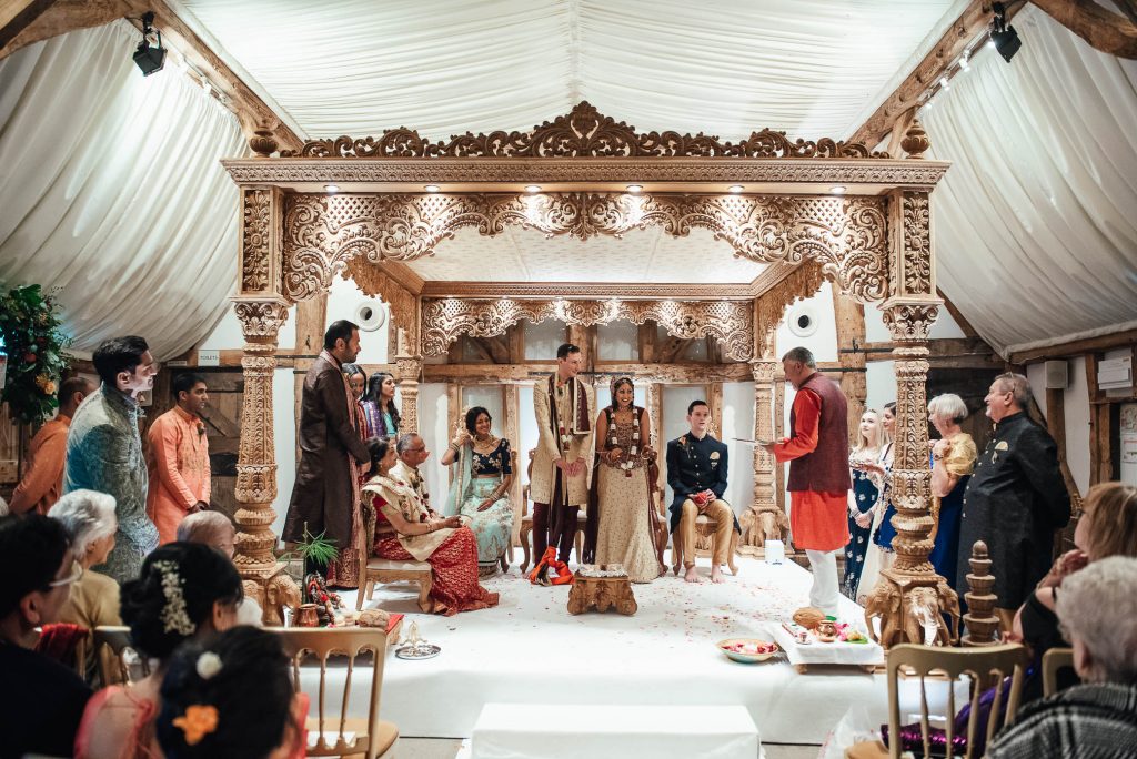 Wedding party sit under the Mandap, Hindu wedding ceremony
