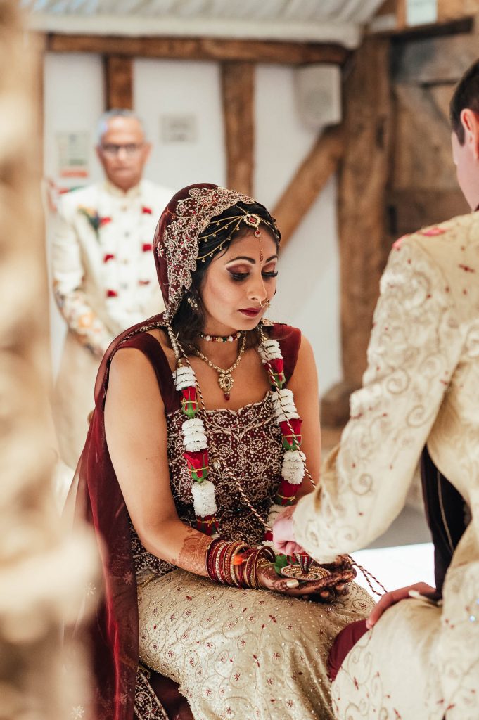 Bride and groom perform wedding ceremony rituals