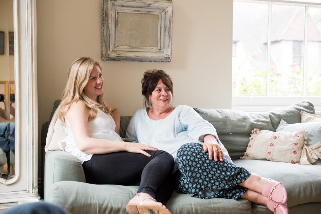 Mother and daughter sit together casually during relaxed London family photography shoot