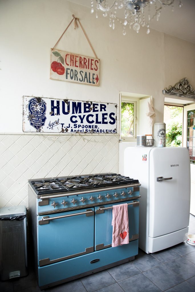 Chic kitchen workspace with bright blue aga cooker