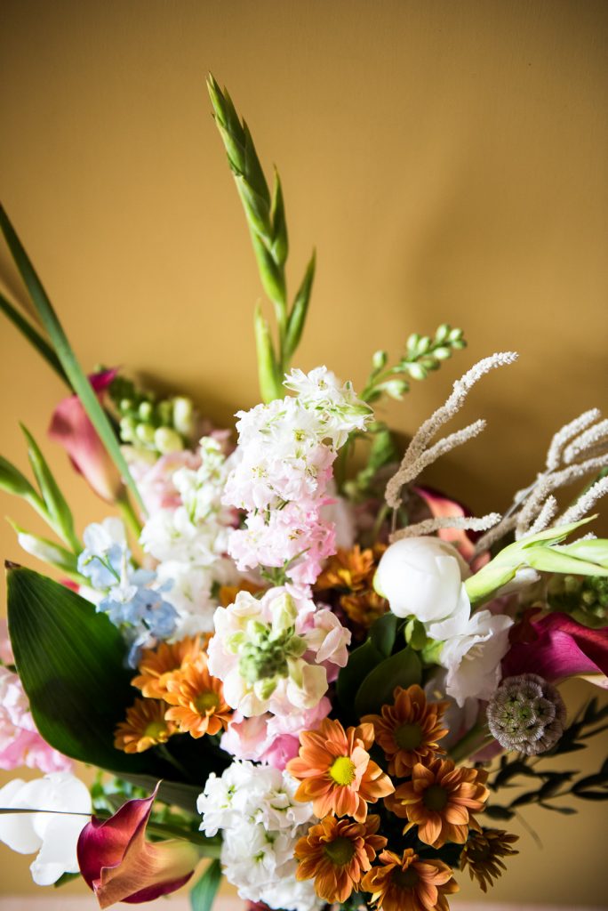 Creative Wedding flower bouquet on mustard orange background