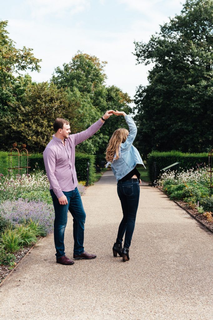 Engaged couple dance together in a London garden