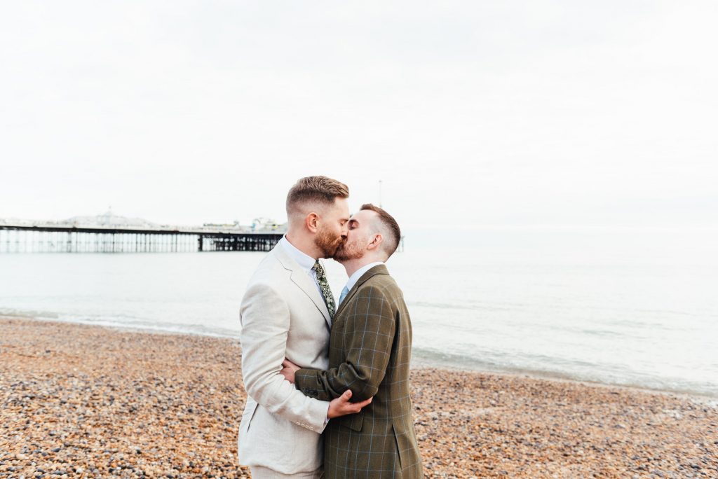 Grooms kiss passionately on Brighton Beach, lgbtq friendly wedding photographer