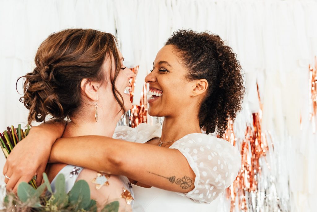 East Sussex wedding photography, brides laugh together on styled wedding shoot