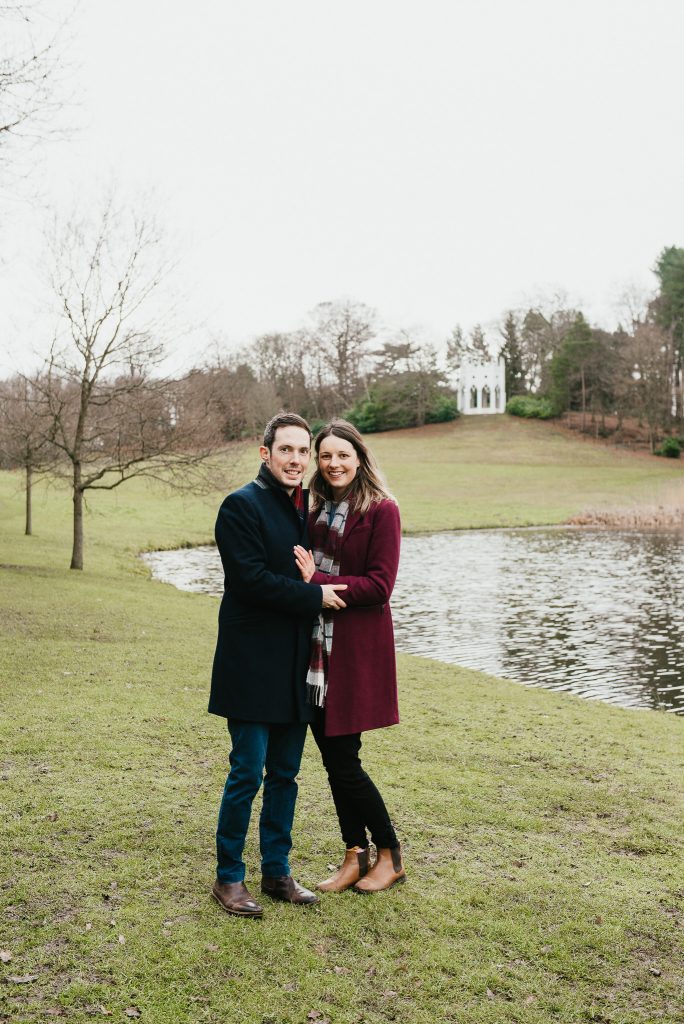 Couple embrace in the grounds of Painshill Park