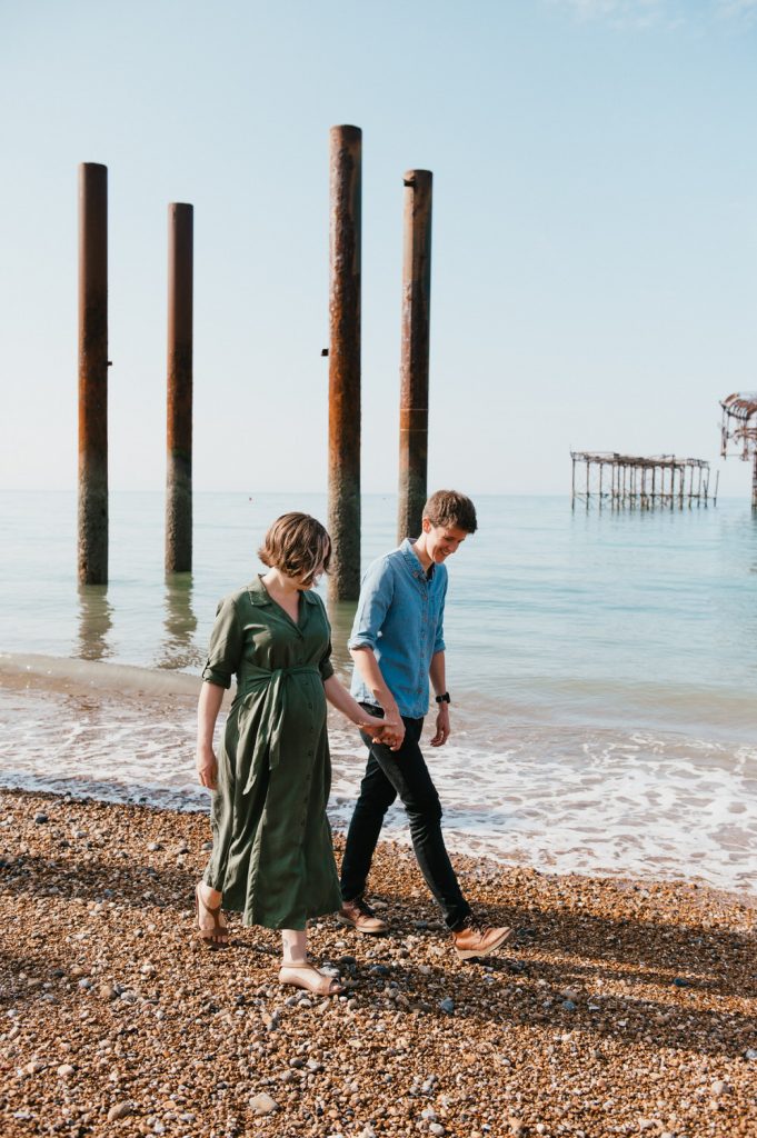Couple walk together on Brighton Beach