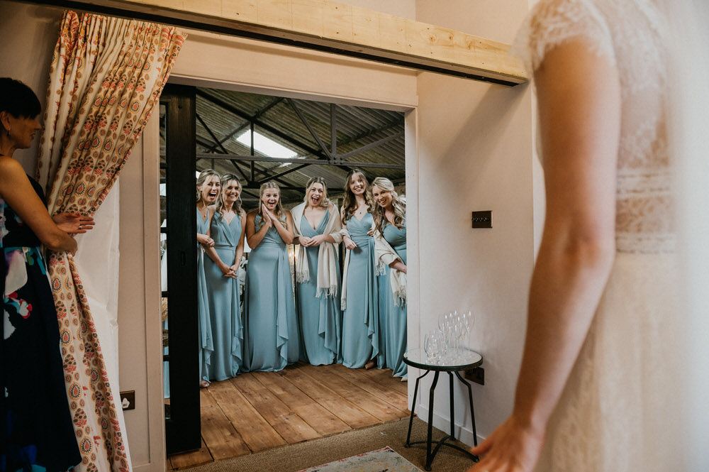 Bride reveals wedding dress to bridesmaids