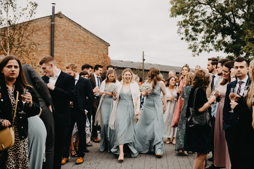Bridesmaids Walk Down Confetti Aisle at Botley Hill Barn Farm Wedding