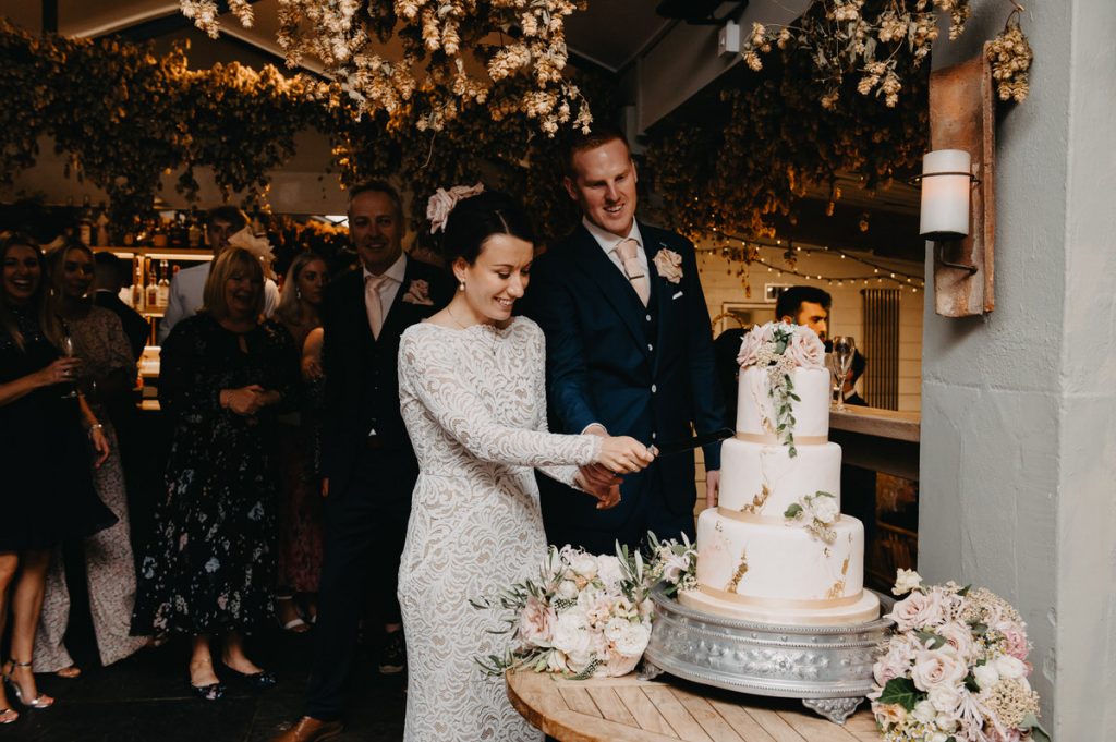 Couple Cut the Wedding Cake Together