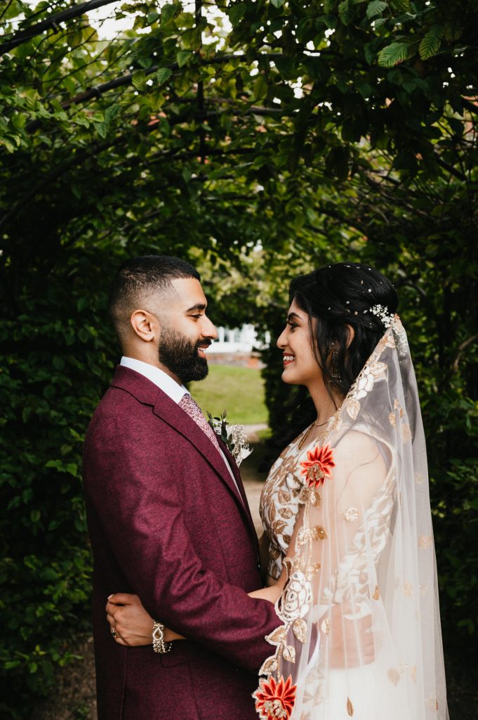 Couple Hug Underneath Floral Canopy, Leatherhead Registry Office Wedding